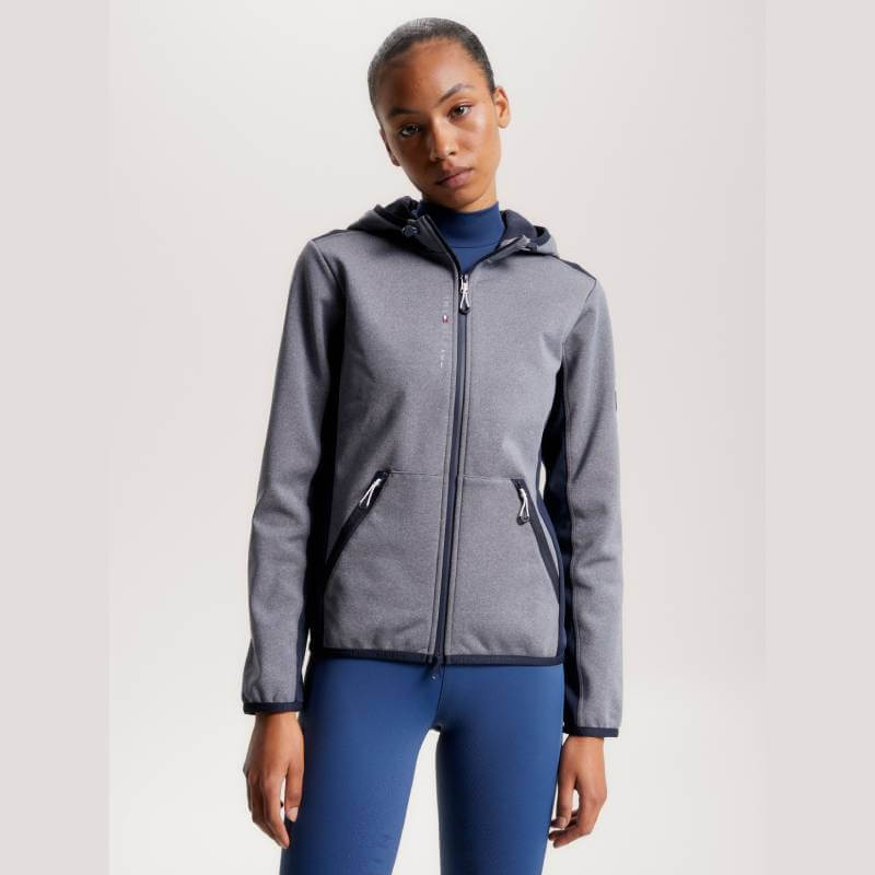 Woman in a Tommy Hilfiger London Softshell Jacket Grey Melange and blue leggings.