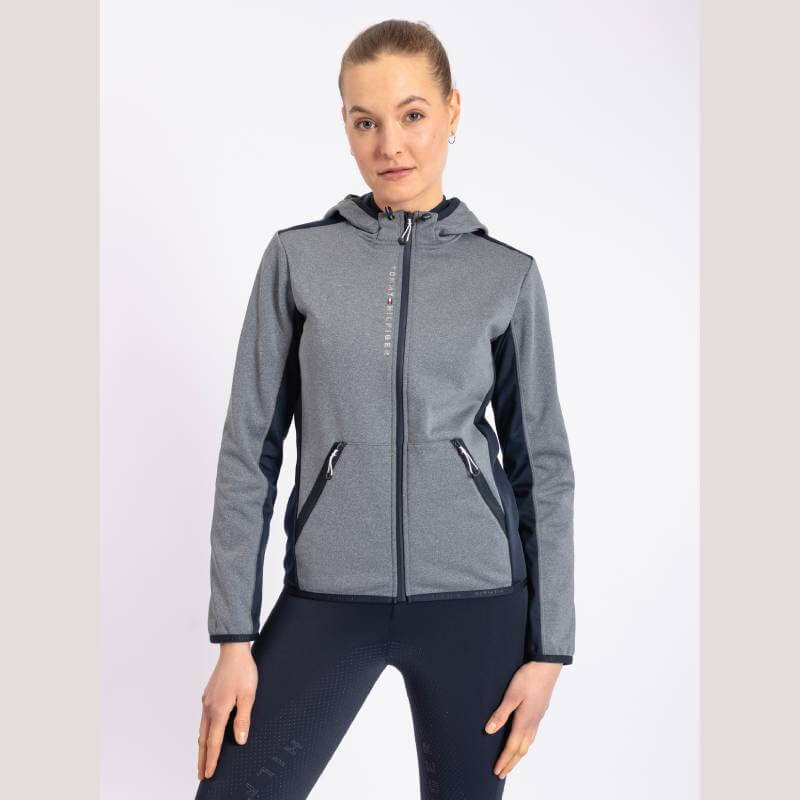 Woman in a Tommy Hilfiger London Softshell Jacket Grey Melange and blue leggings.