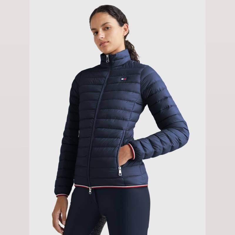 Woman in a Tommy Hilfiger Light Re-Down Jacket Desert Sky with hands in pockets.