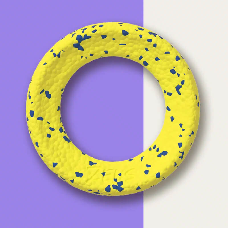 The Zeus Nitro Weighted Ring: a yellow ring with blue specks on a purple and off-white background.