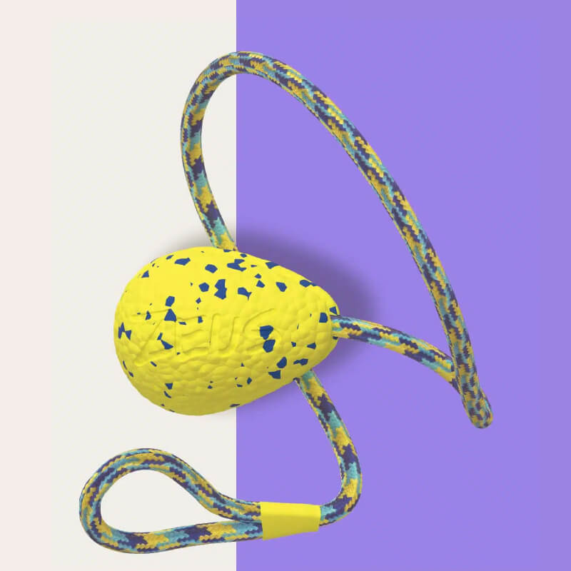 Zeus Nitro Weighted Slinger with Rope: durable yellow speckled toy on cream, purple background.