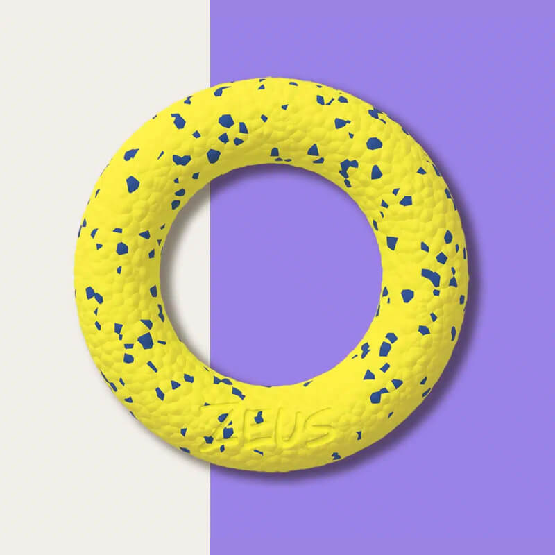 Zeus Nitro Ring dog toy on a split white and purple background.