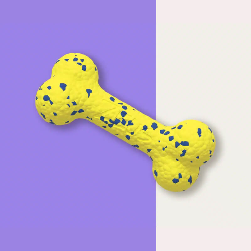 Zeus Nitro Bendy Bone: flexible yellow dog toy with blue specks on a split purple background.