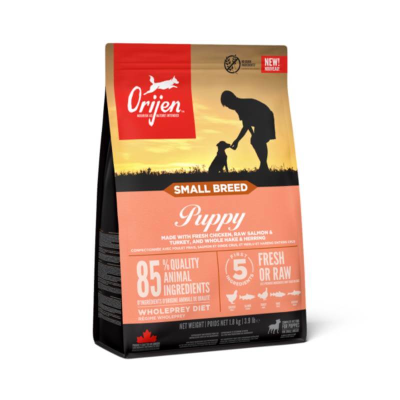 Orijen Small Breed Puppy: high-protein food; bag shows person &amp; puppy silhouette at sunset.