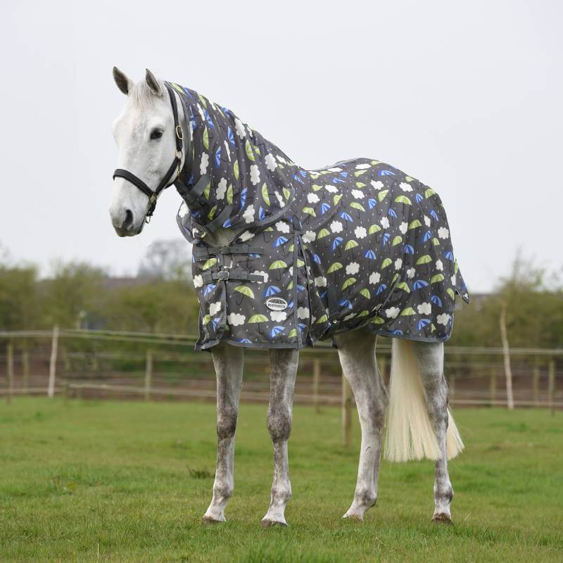 A white horse wears the Weatherbeeta Comfitec Essential Mesh II Combo Neck Umbrella Print fly rug.