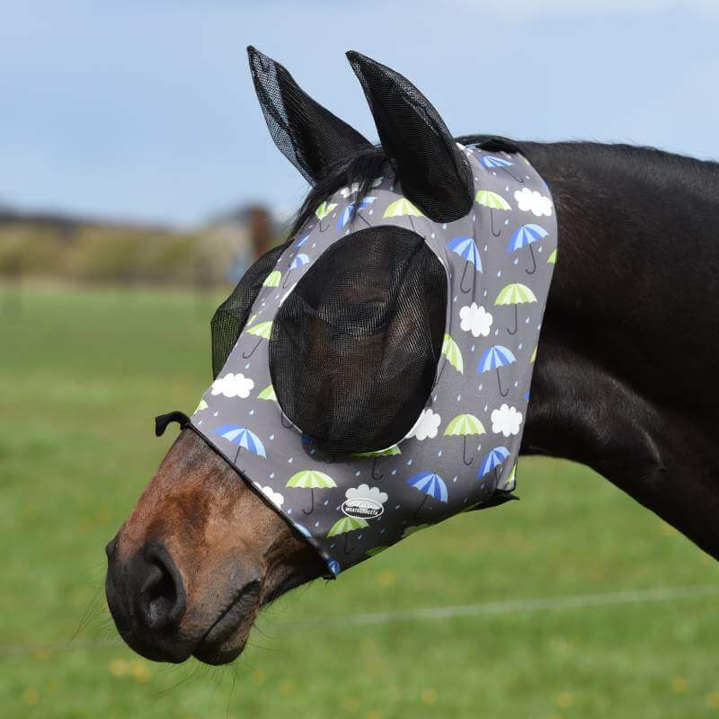 A horse wearing the Weatherbeeta Deluxe Stretch Bug Eye Saver With Ears in an umbrella print.
