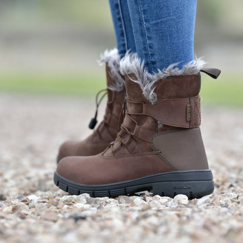 Dublin Boyne Boots Brown Adult with fur lining, worn with blue jeans, side view.