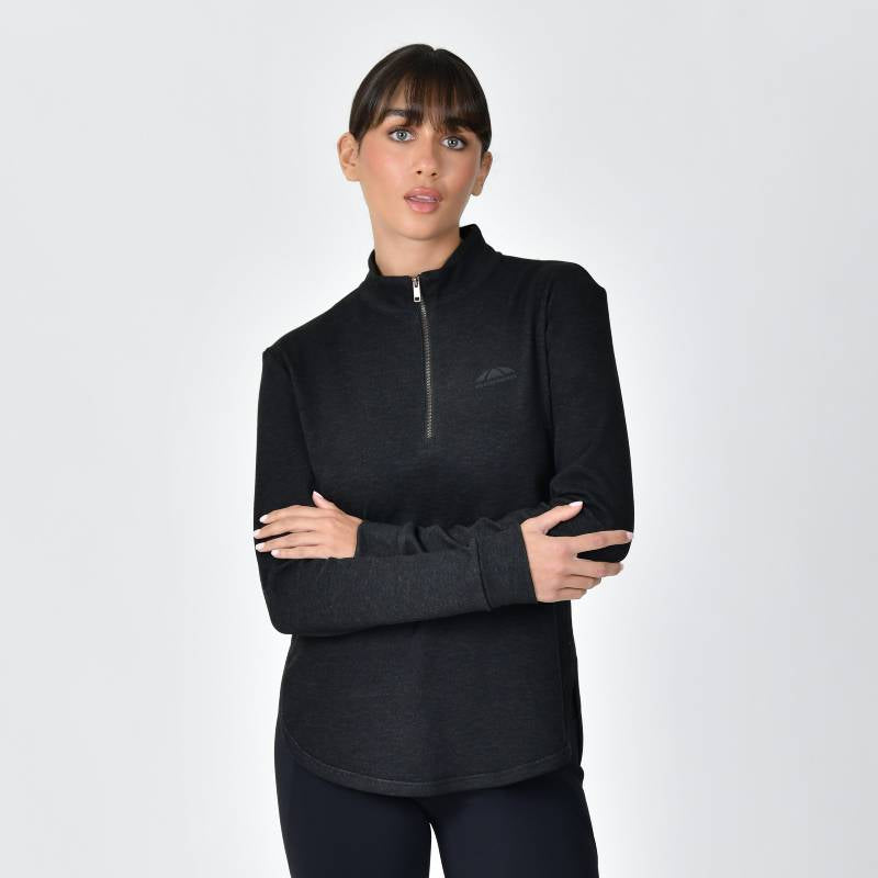 Woman in Weatherbeeta London Layer Long Sleeve Top Black Marle, arms crossed, plain background.