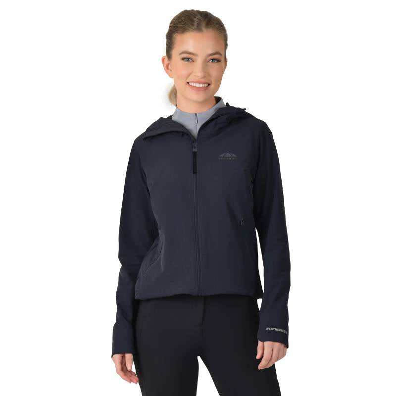 Woman smiling in a Weatherbeeta Abrasion Proof Stretch Riding Jacket Navy and leggings.