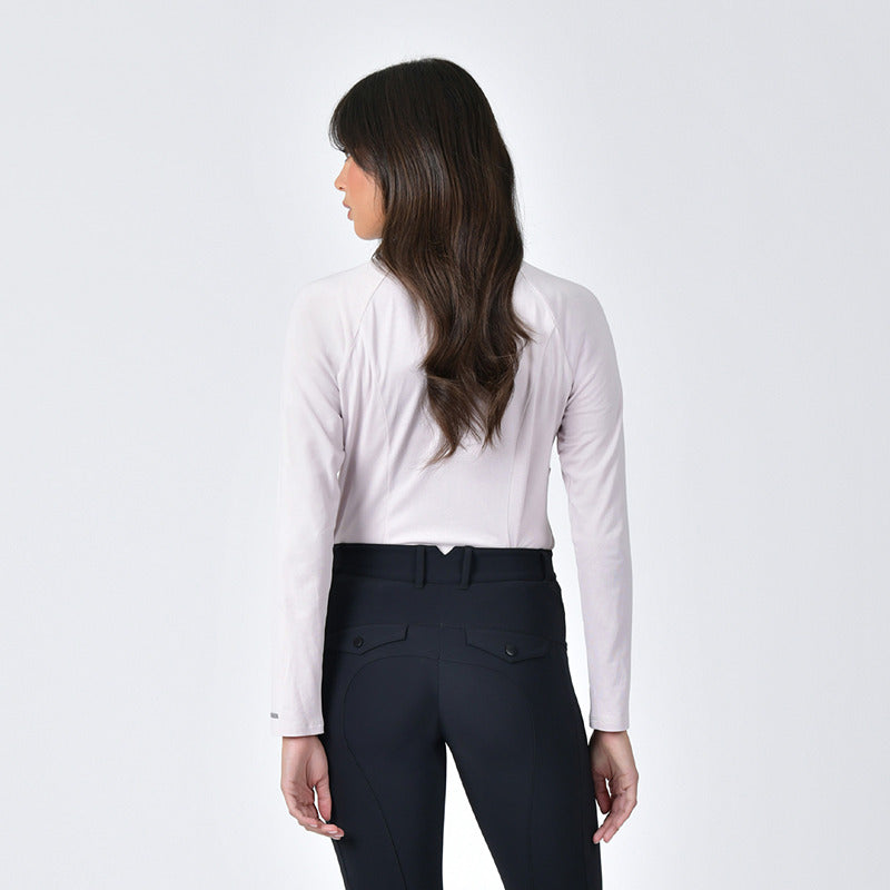 Woman facing away in Weatherbeeta Bamboo Long Sleeve Base Layer Lavender Mist, dark pants.