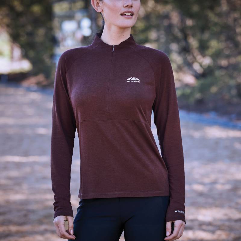 Woman outdoors in a Weatherbeeta Bamboo Long Sleeve Base Layer Mulberry and black pants.