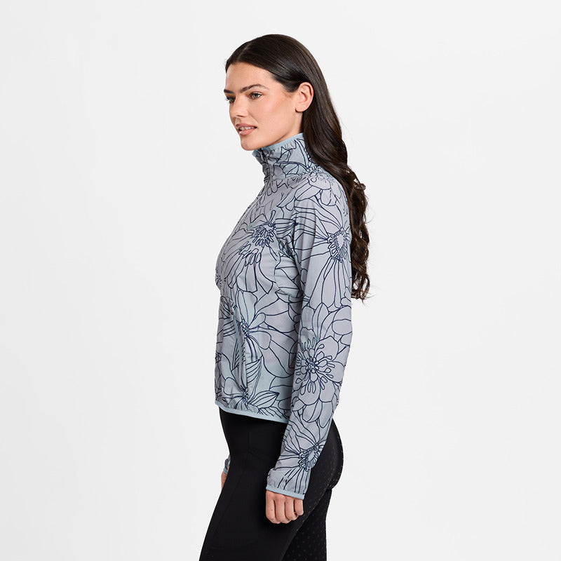 Woman in a Weatherbeeta Lightweight UV Jacket in Bluestone/In Bloom, standing in profile.