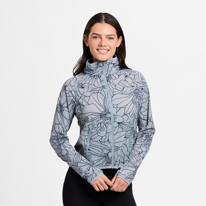 Woman in a Weatherbeeta Lightweight UV Jacket Bluestone/In Bloom, smiling against white background.