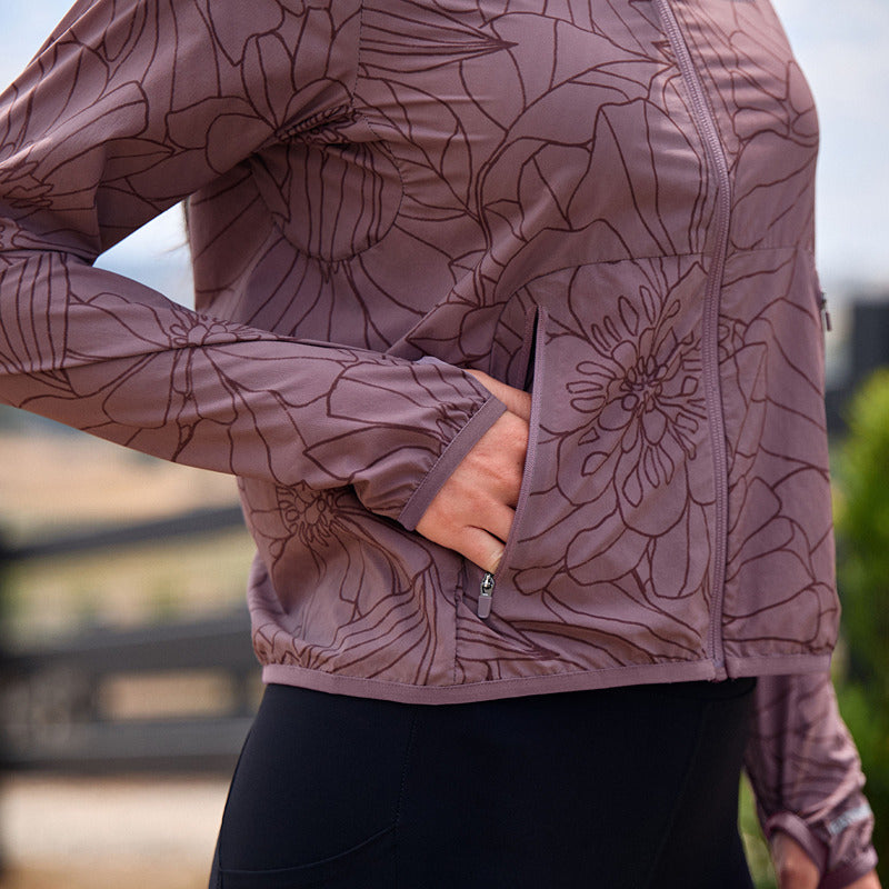 Person in a Weatherbeeta Lightweight UV Jacket Mauve Wine/In Bloom with hand in pocket outdoors.