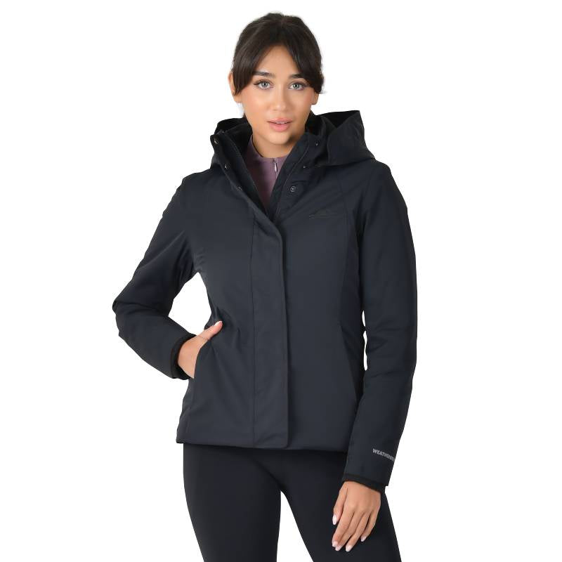 Woman wearing the Weatherbeeta Protect Jacket With High Neck Black, hand on her hip.