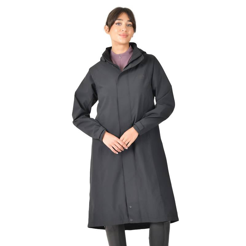 Woman wearing a Weatherbeeta Windbreaker Longline Riding Jacket in Black, facing forward.