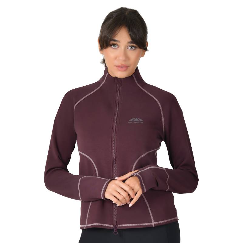 Woman in a Weatherbeeta Copper Performance Jacket Mulberry stands against a white background.