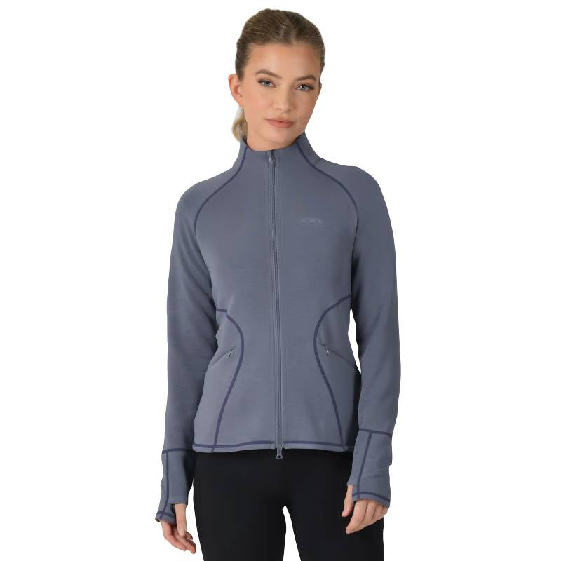 Woman wears the Weatherbeeta Copper Performance Jacket in slate blue with black pants.