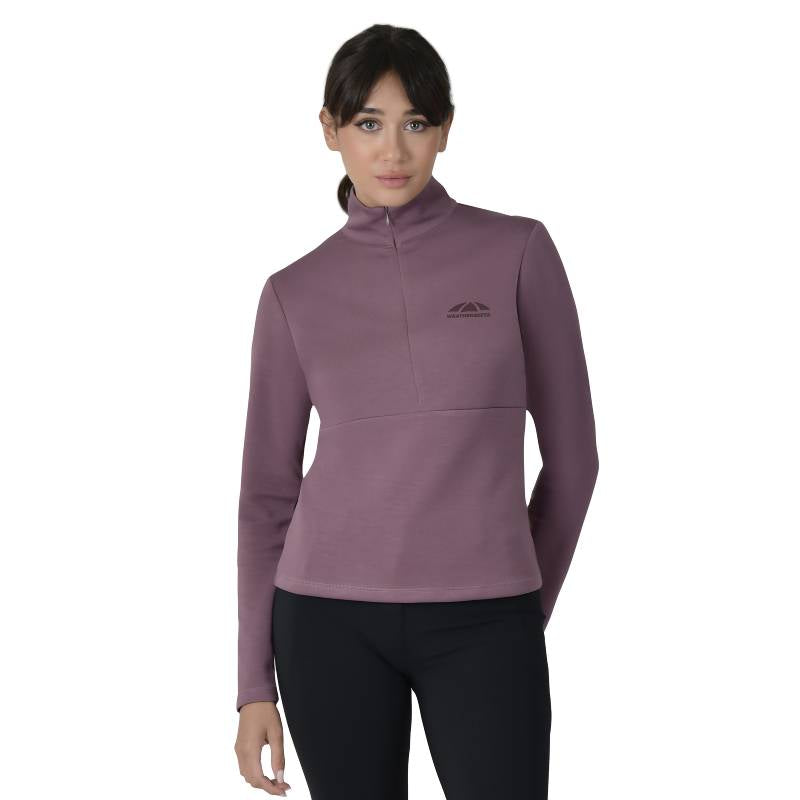 Woman in Weatherbeeta mauve wine 1/2 zip long sleeve mid-layer, white background.