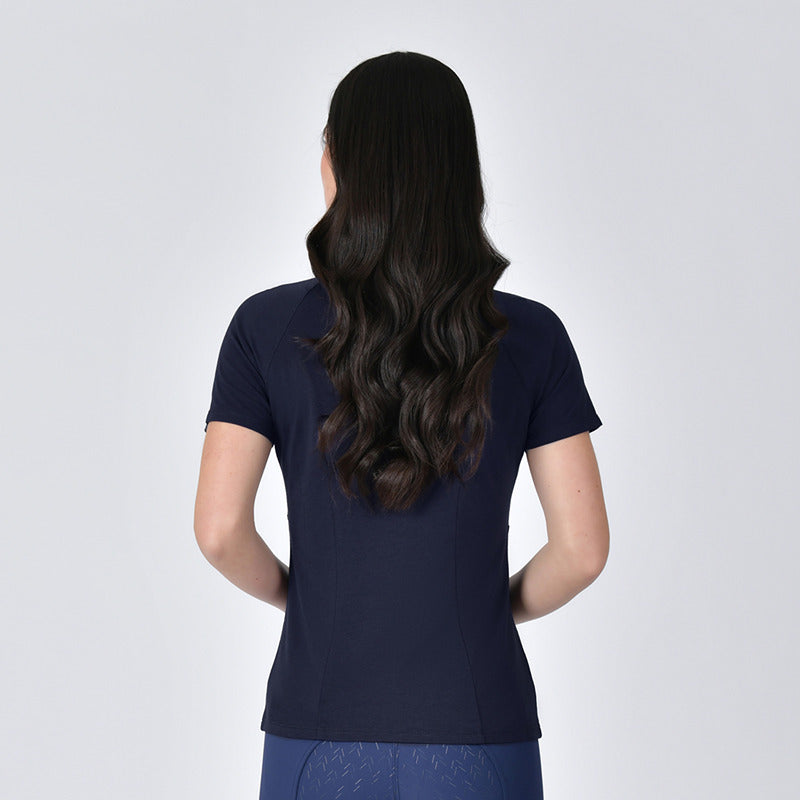 A woman with long wavy hair wears a Weatherbeeta navy Bamboo Base Layer, back to the camera.