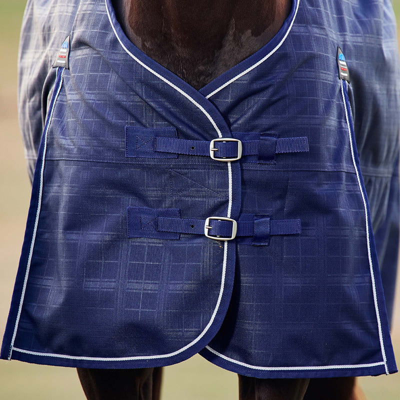 Close-up of a horse in a Weatherbeeta Comfitec Prelim navy embossed plaid turnout rug.