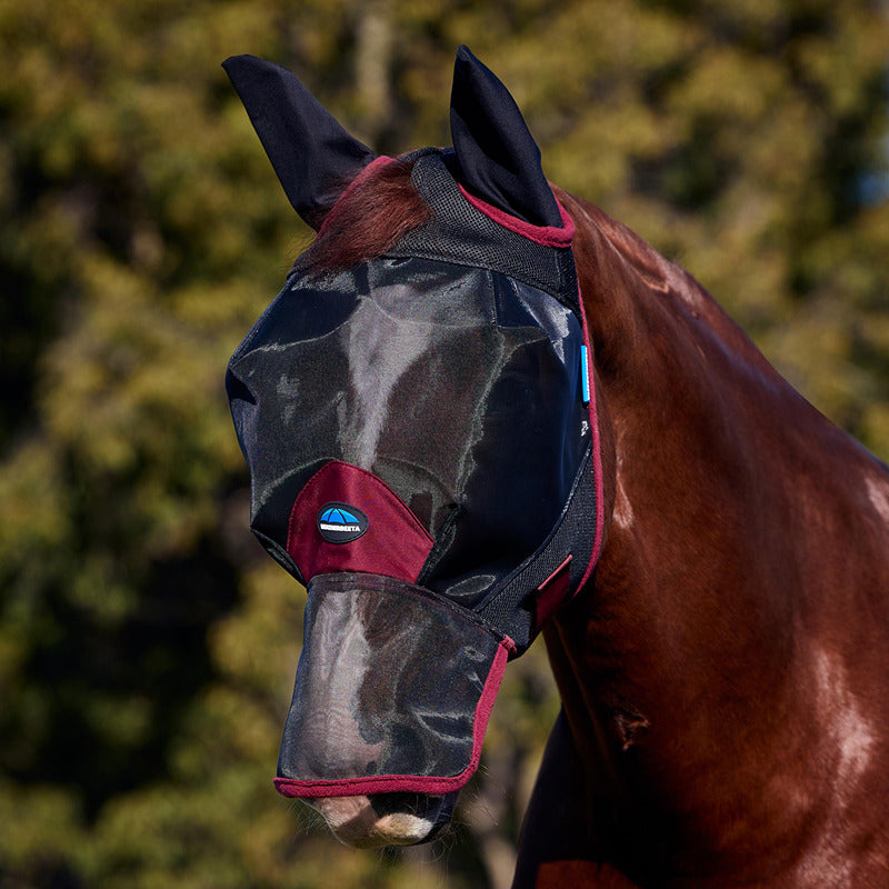 A horse wears the Weatherbeeta Comfitec Fine Mesh Fly Mask with ears &amp; nose in black/burgundy.