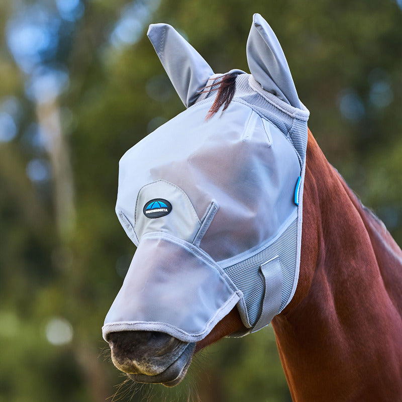 A horse outdoors in a Weatherbeeta grey fine mesh fly mask with ear and nose covers.