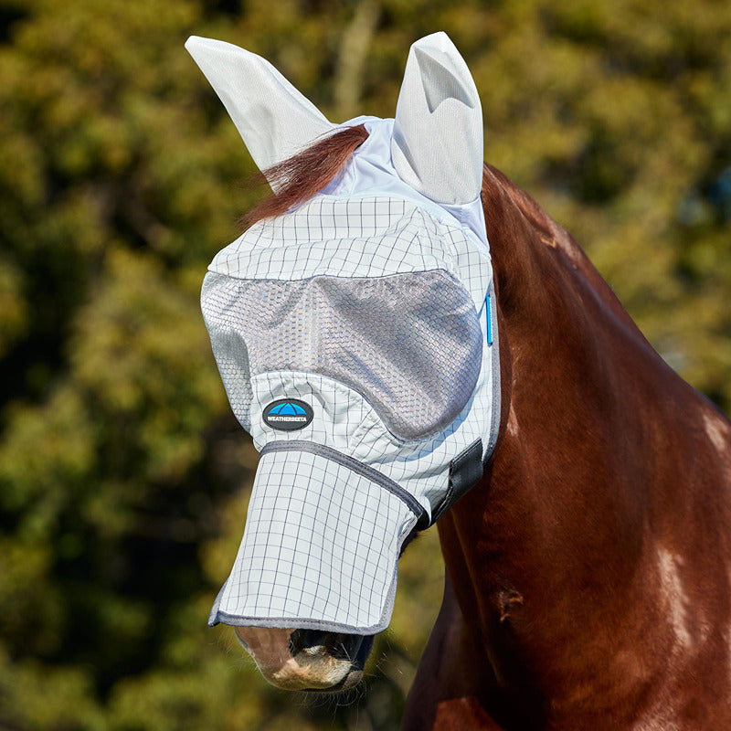 Brown horse outdoors in Weatherbeeta Hybrid Fly Mask White/Charcoal with ear and nose covers.
