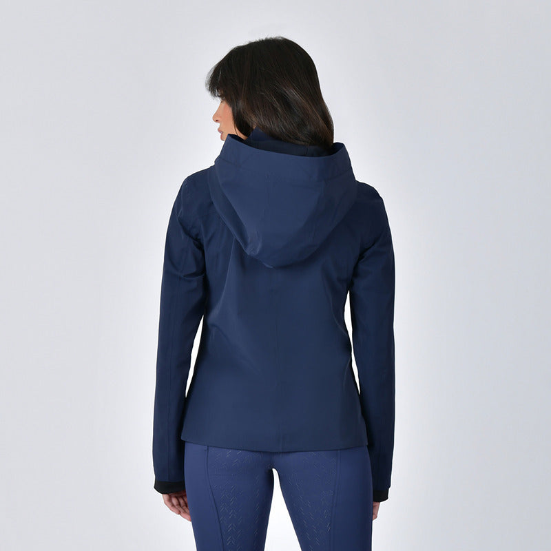 Woman in a Weatherbeeta Protect Waterproof Riding Jacket Navy, back to the camera.