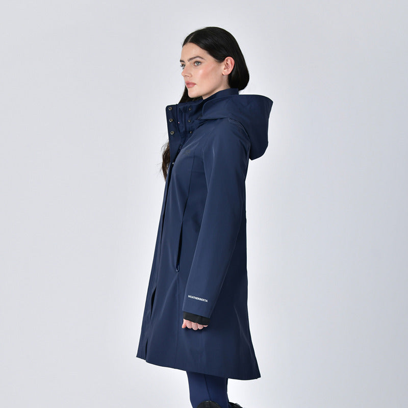 Woman in a Weatherbeeta Protect Waterproof Longline Riding Jacket Navy against a plain background.