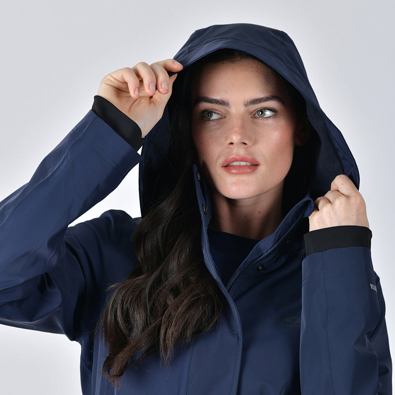 Woman in a Weatherbeeta Protect Waterproof Longline Riding Jacket Navy looks to the side.