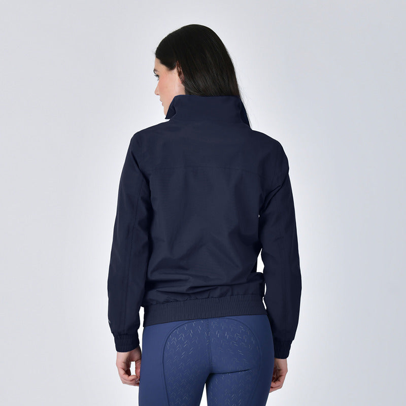 Woman in a Weatherbeeta Waterproof Team Jacket Navy and leggings, back to the camera.
