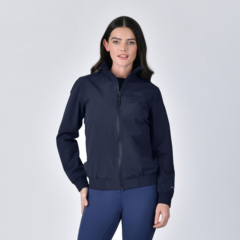 Woman wearing the Weatherbeeta Waterproof Team Jacket Navy against a plain light background.