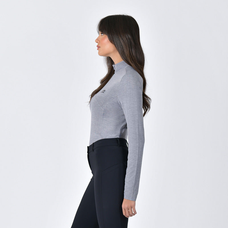 Woman in a Weatherbeeta 37.5 1/4 Zip Top Mauve Wine Marle and black pants in profile.