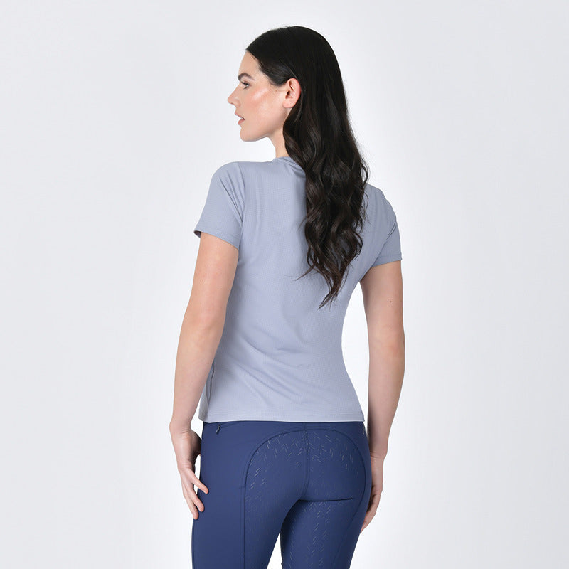 Woman in Weatherbeeta Relaxed Copper UV Short Sleeve Tee Bluestone, facing away.