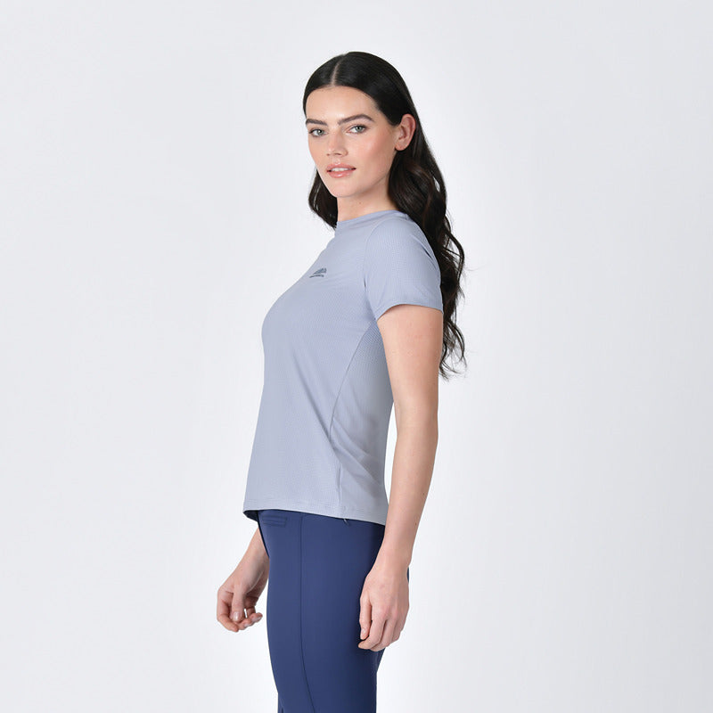 Woman in Weatherbeeta Relaxed Copper UV Tee Bluestone and navy leggings, standing sideways.