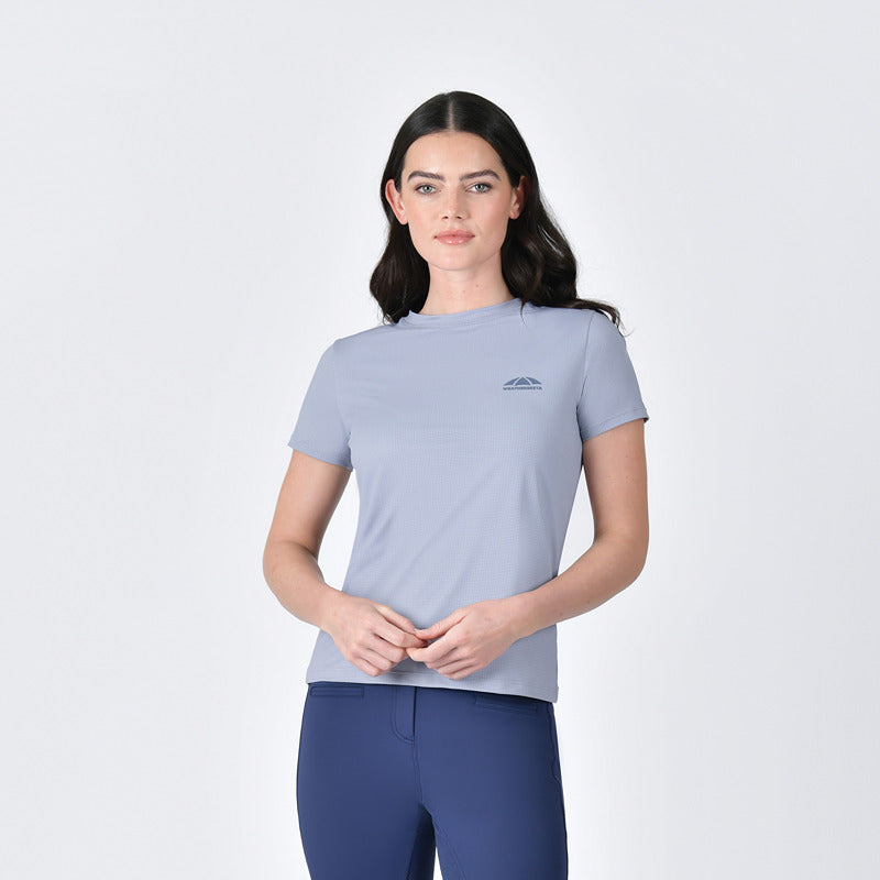 Woman in Weatherbeeta Relaxed Copper UV Tee Bluestone and dark blue leggings on white background.