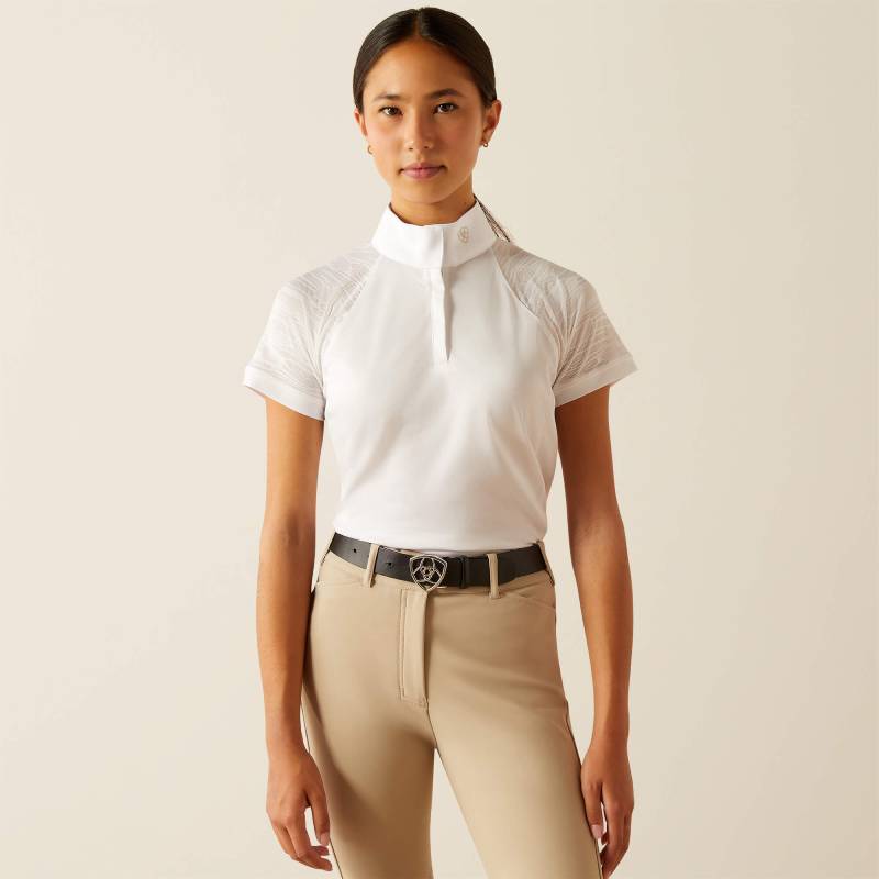 Girl wears Ariat Youth Aptos Vent 2.0 SS Show Shirt White and beige riding pants against plain background.