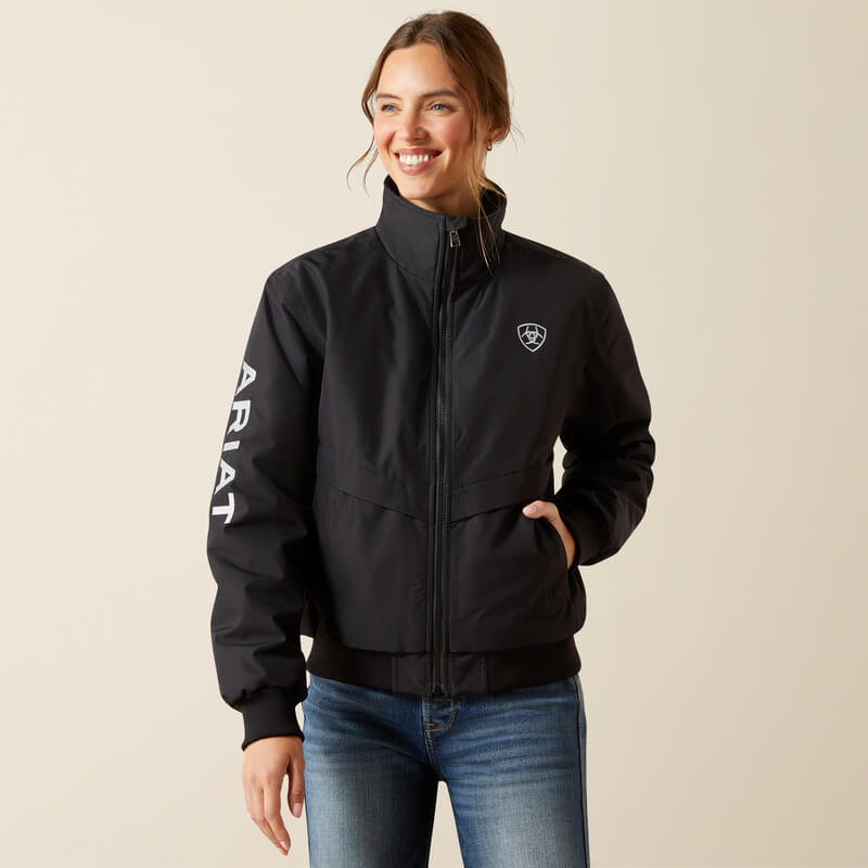 Smiling woman in an Ariat Womens Stable 2.0 Insulated Jacket Black and blue jeans.