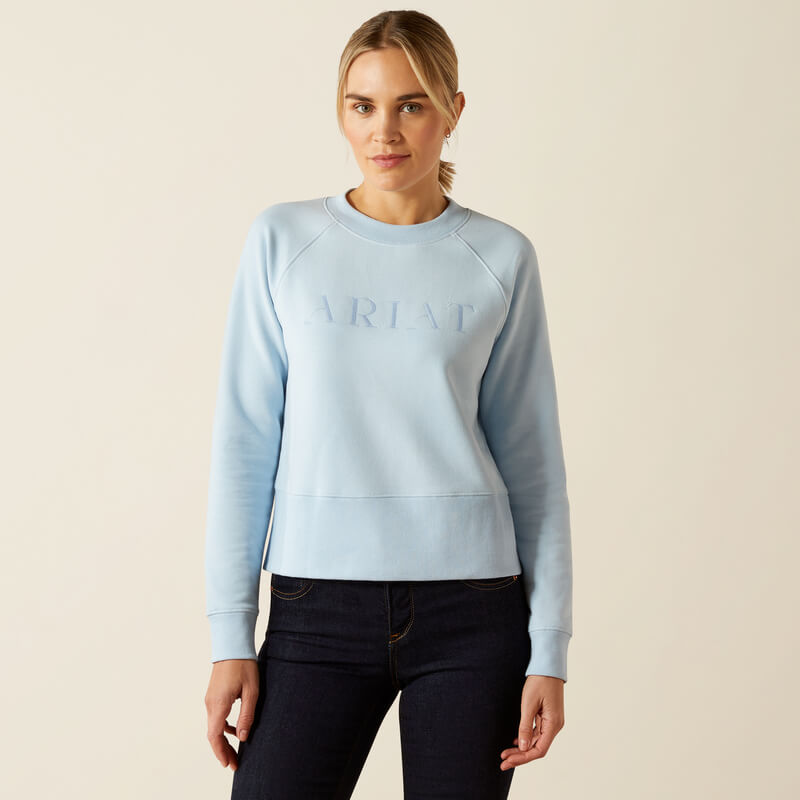 Woman in a Skyway Ariat Womens Martine Sweatshirt and dark jeans, against a plain background.