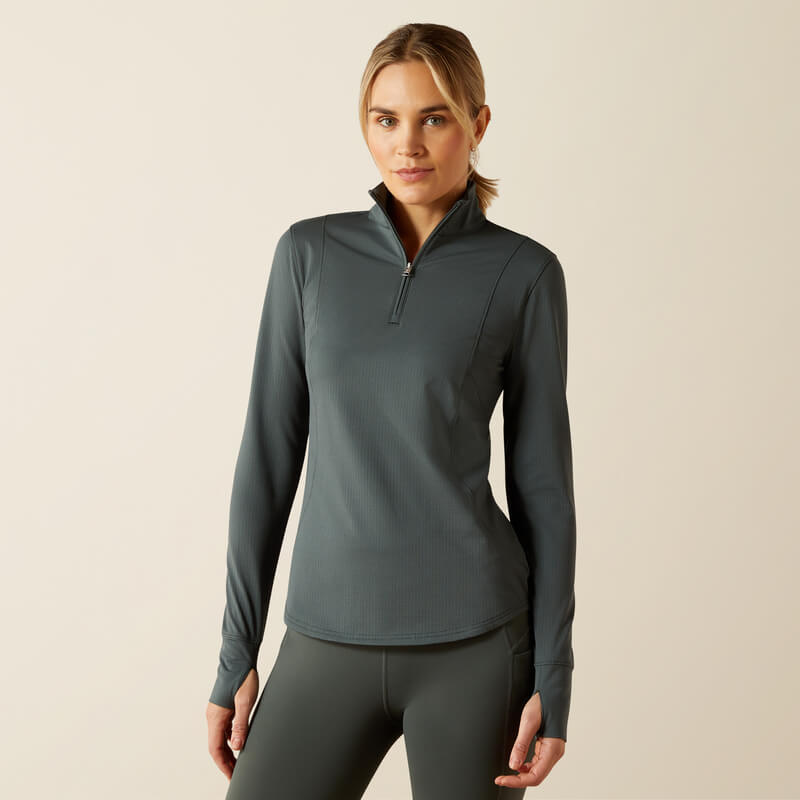Woman in an Ariat Womens Gridwork 2.0 1/4 Zip Baselayer Urban Chic, plain background.