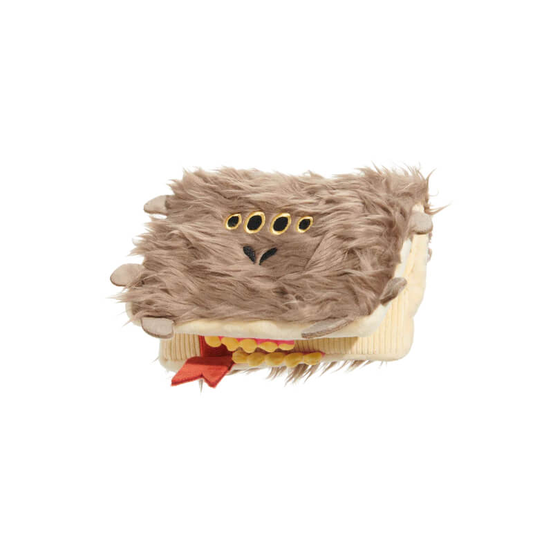 BARK Harry Potter Book of Monsters Dog Toy with furry face, yellow eyes, and felt tongue.