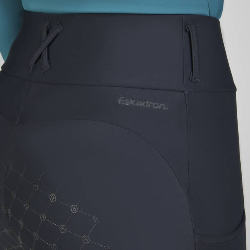 Close-up of Eskadron Heritage Cosy Riding Tights Black with logo and full grip hexagonal pattern.