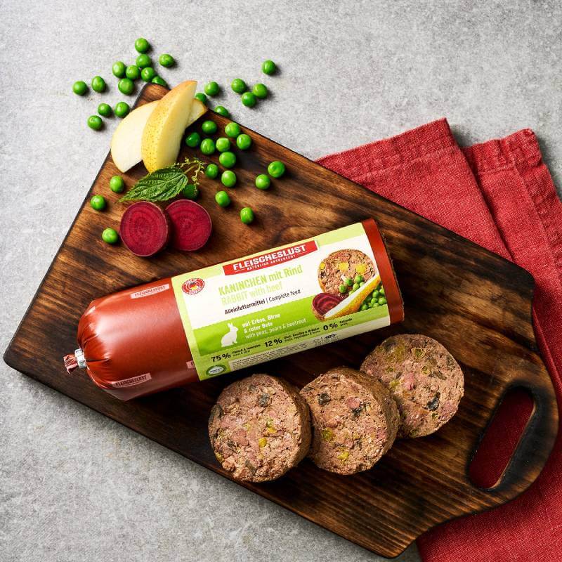 Fleischeslust Rabbit with Beef, Peas, Pear &amp; Beetroot 400g roll on board with red napkin.