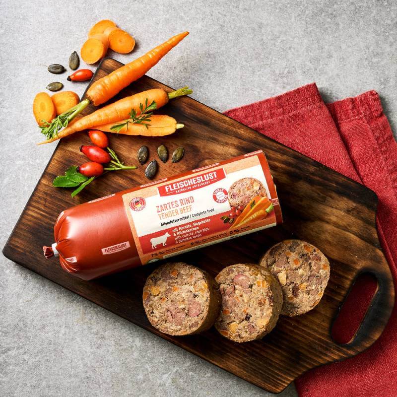 Fleischeslust Tender Beef Roll with Carrots, Rose Hips &amp; Pumpkin Seeds 400g on cutting board.