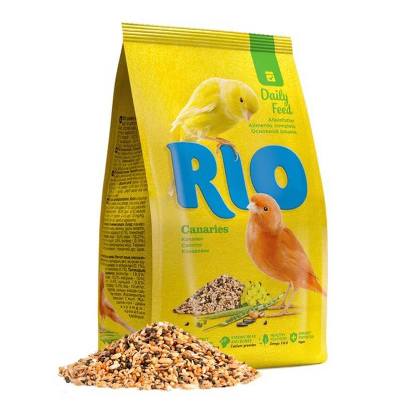 A yellow 500g bag of Rio Canaries Daily Feed with canaries and feed shown in front.