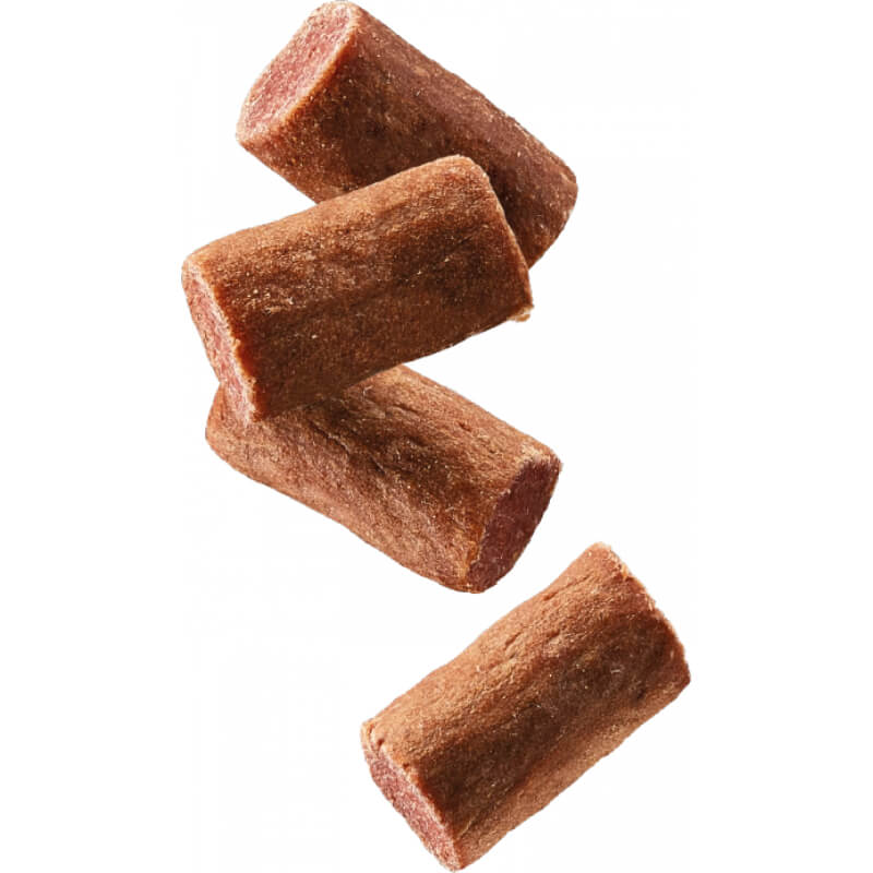 Four Natures Menu Meaty Treats Beef sticks stacked diagonally on a white background.