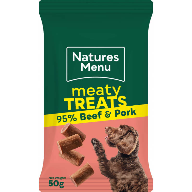 Dog with raised paw near Natures Menu Meaty Treats Beef, high-protein dog treats, 50g.