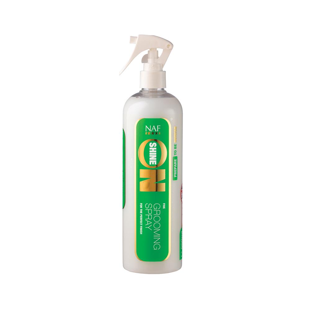 A white NAF Shine On Grooming Spray bottle for horse coat shine with green and yellow design.