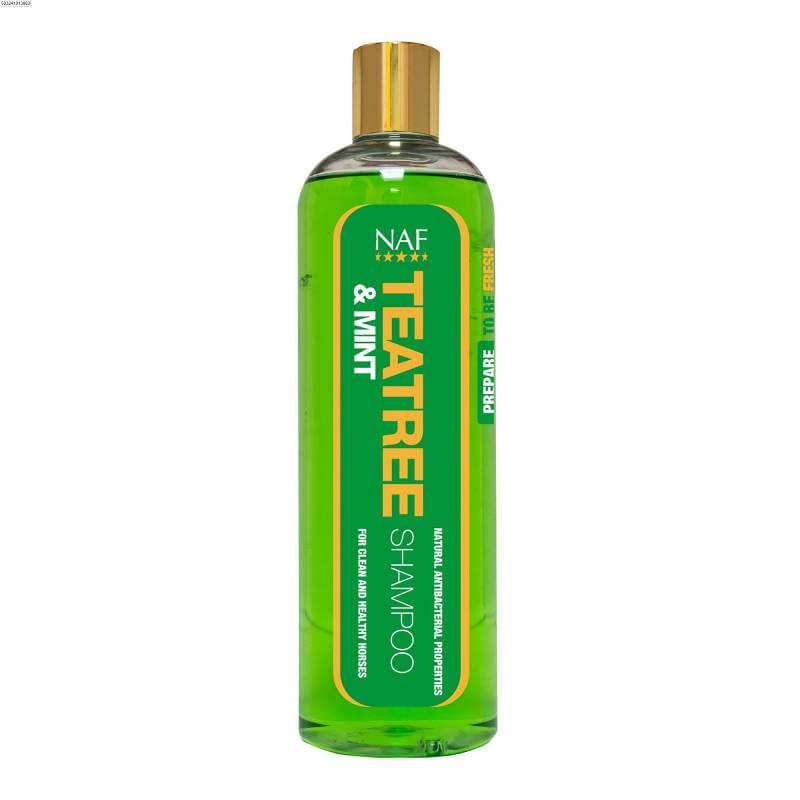 A clear bottle of NAF Teatree &amp; Mint Shampoo 500ml with green liquid and gold cap.